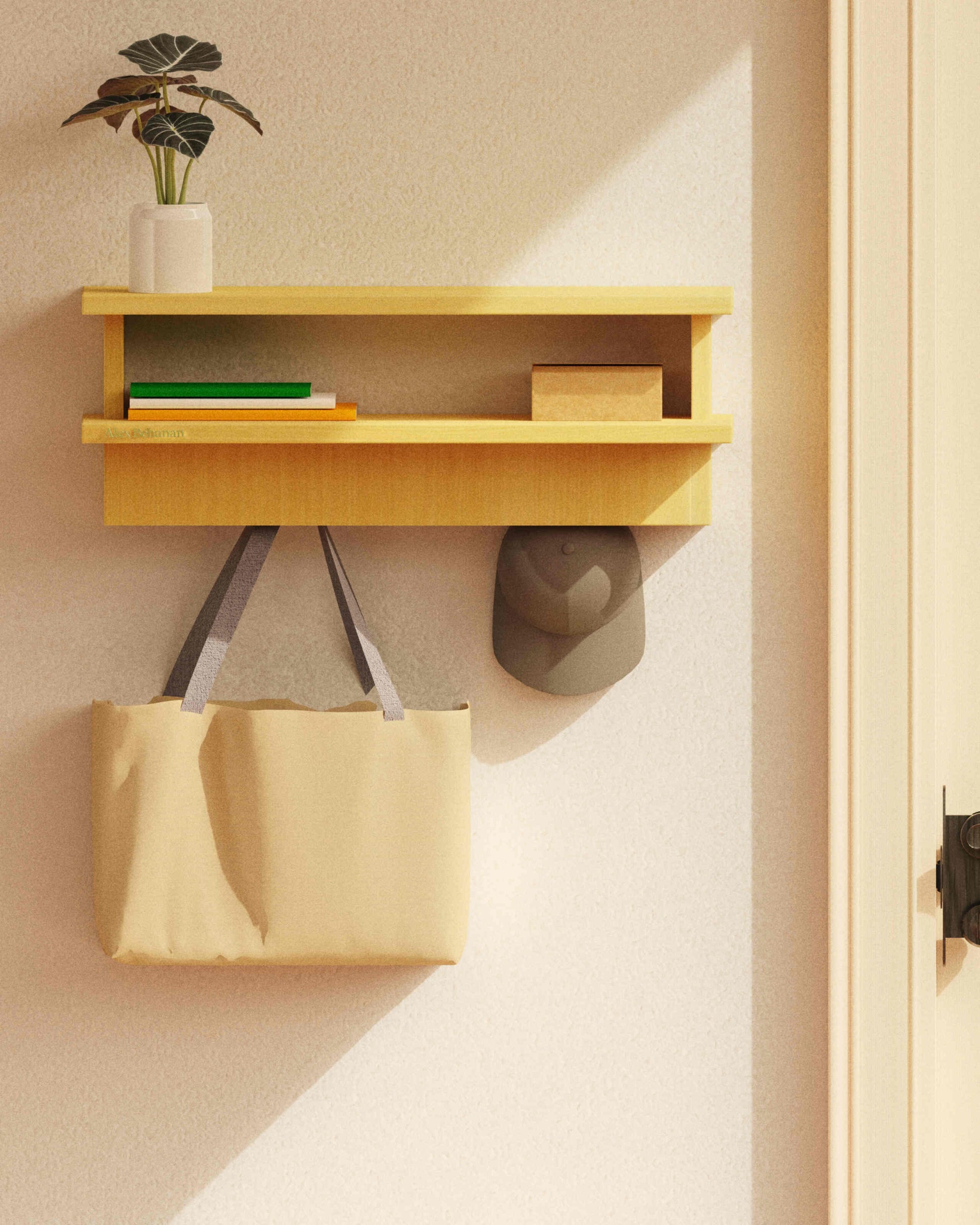 Wooden shelf with a plant, books, and a box on a beige wall with a beige bag hanging below.